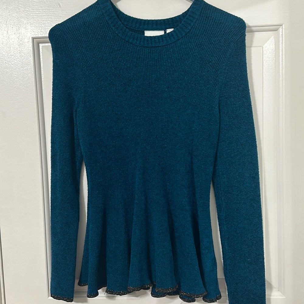Anthropologie teal long sleeved sweater with ruffled hem.